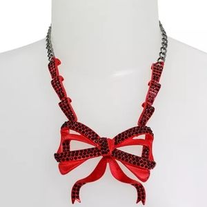 Betsey Johnson necklace featuring festive vibrant red fancy flowy bow pendant